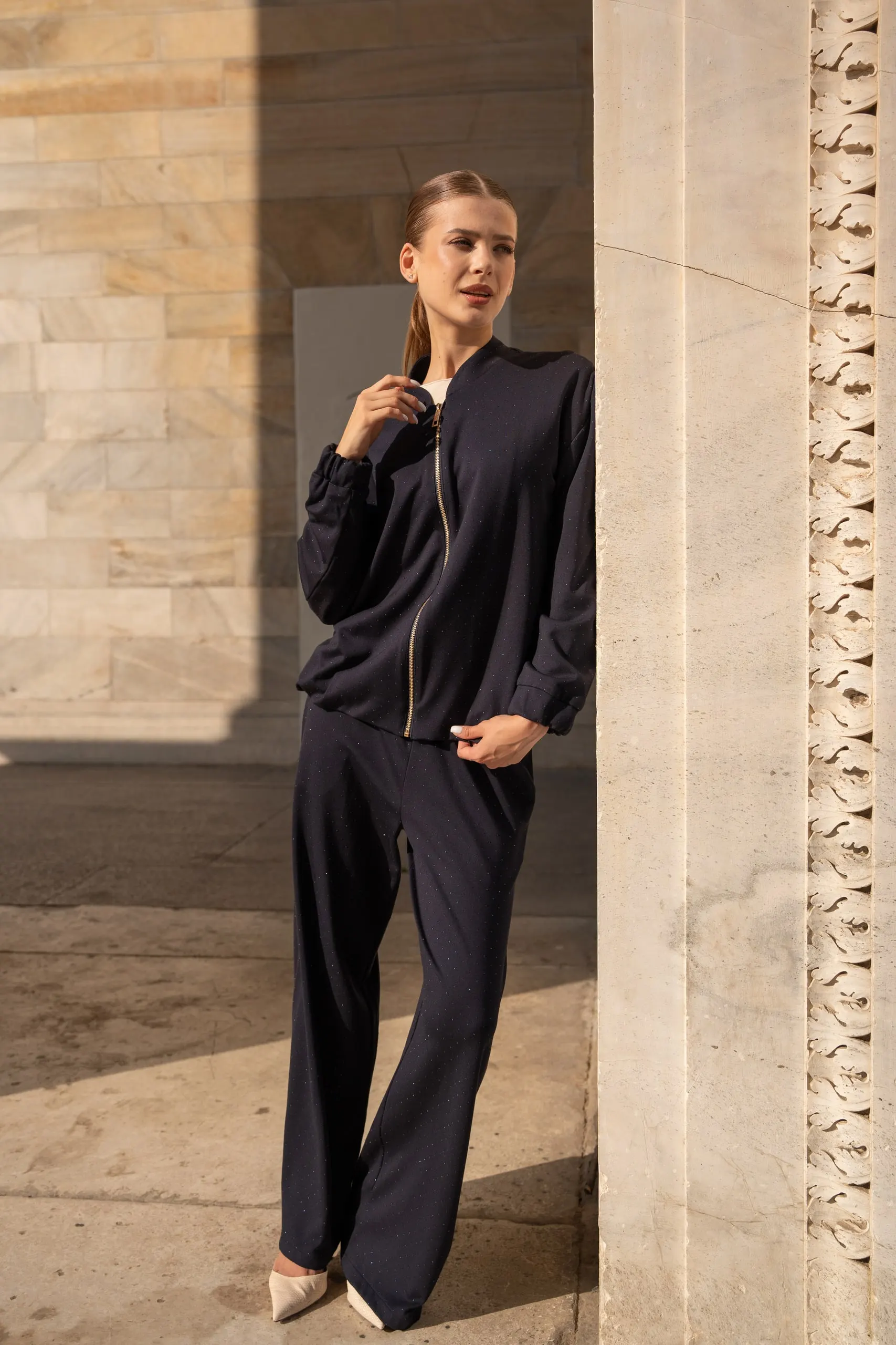 Atelier èmi — navy zip jacket, marble columns