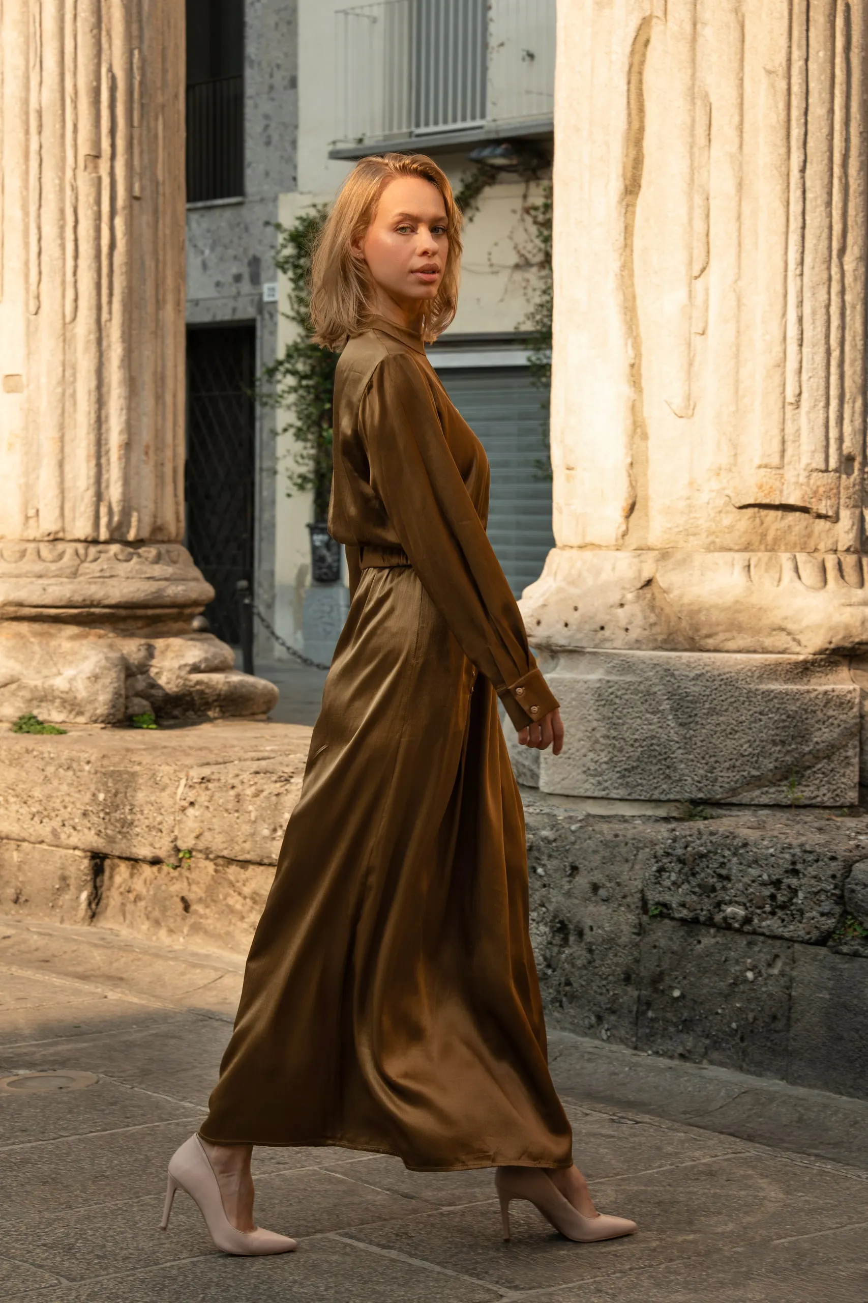 Clothé — olive satin dress by the Roman columns