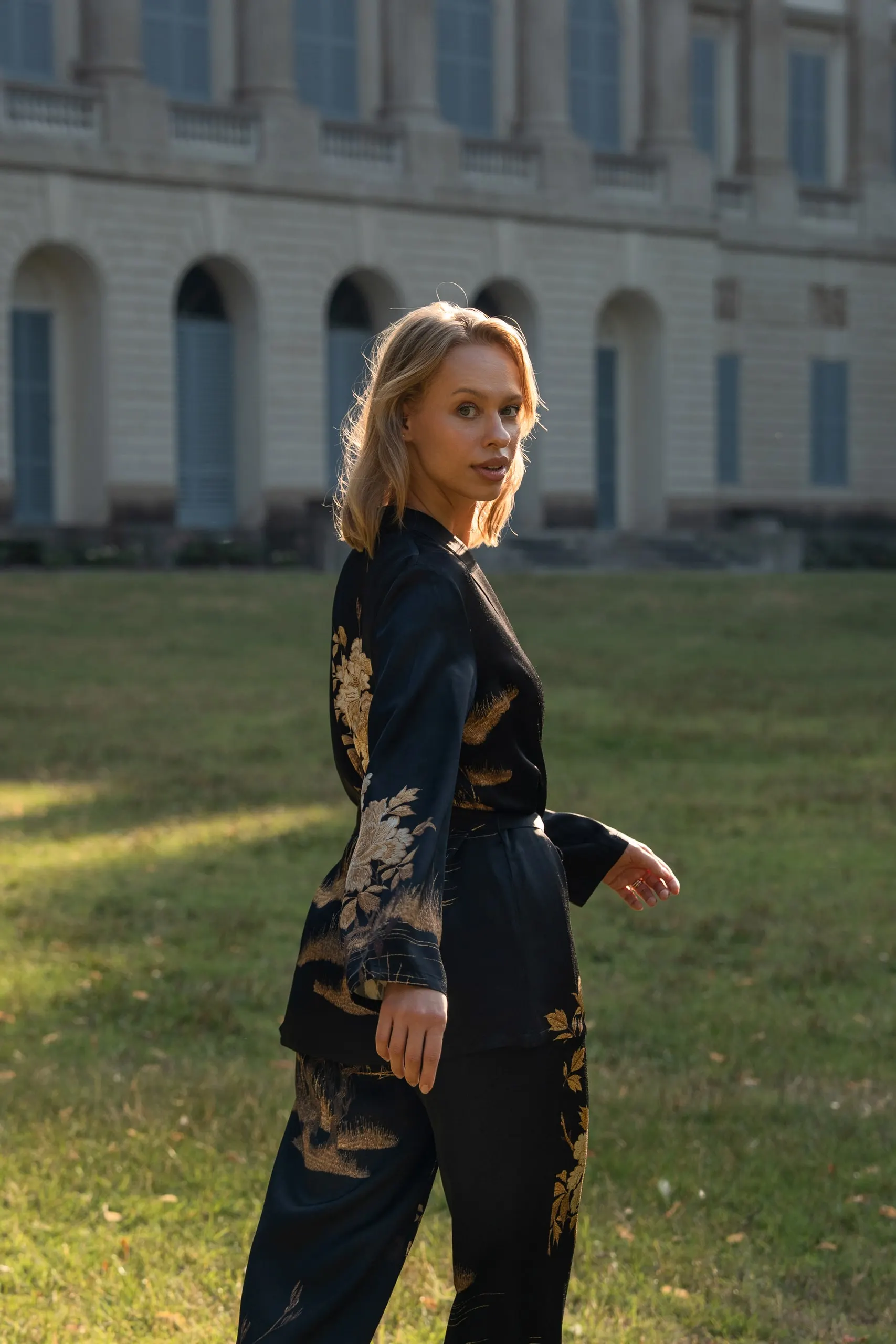Clothé — black floral suit on the lawn