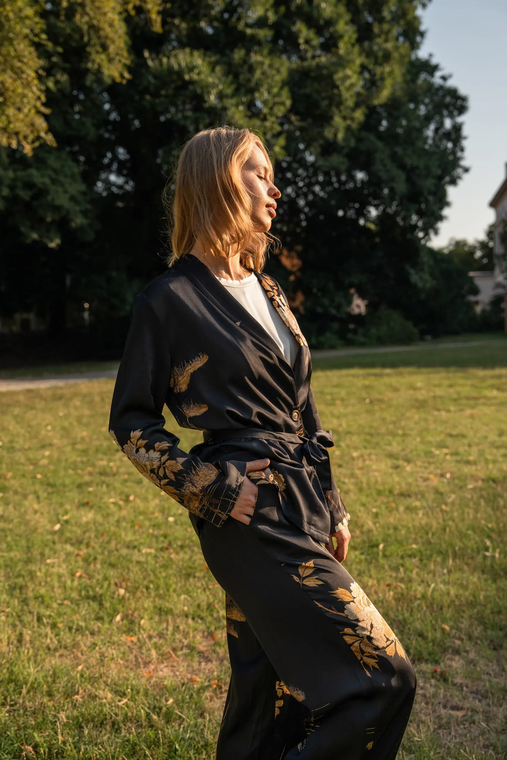 Clothé — black floral suit, in profile
