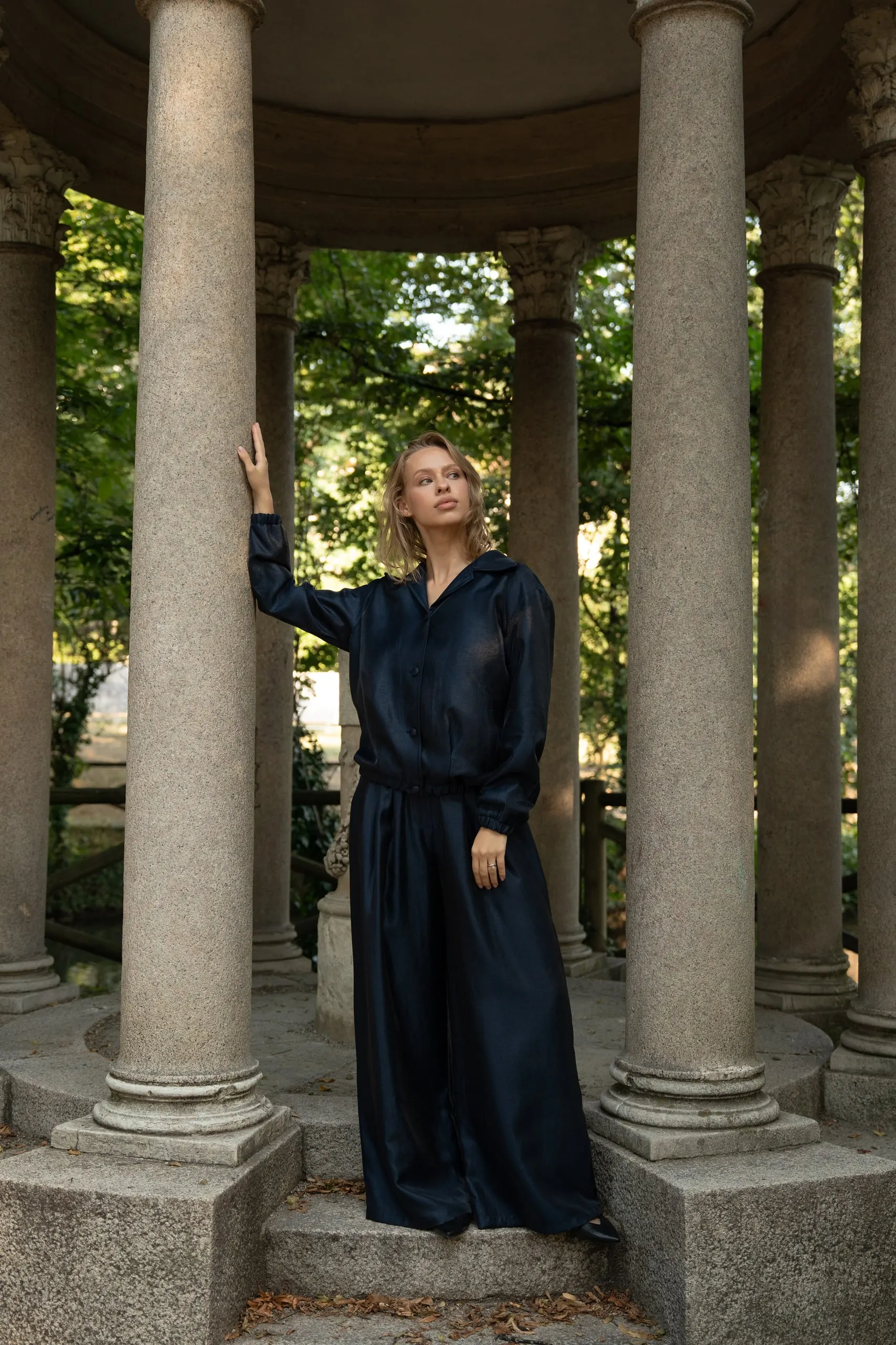 Clothé — navy satin in the colonnade