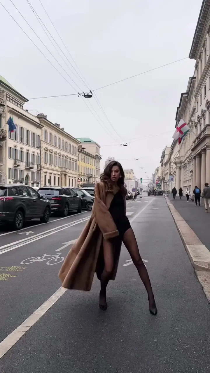 fashion reel in Milan — fur coat and black dress