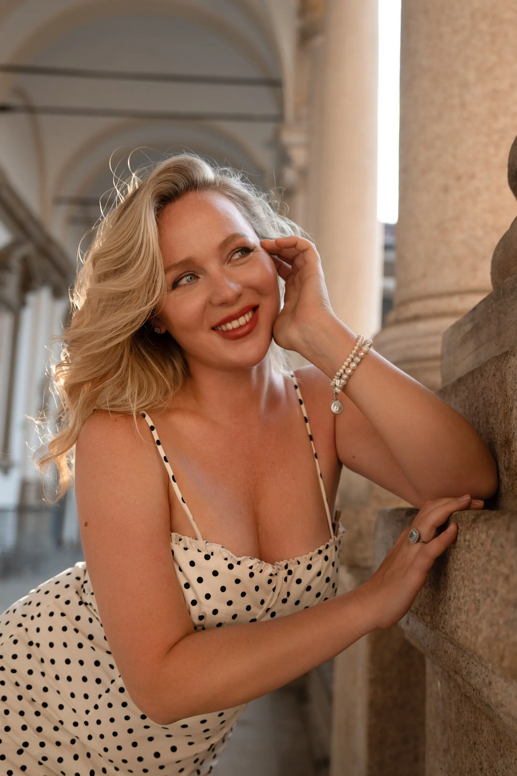 Yulia — a private shoot in Milan — by the column, smiling