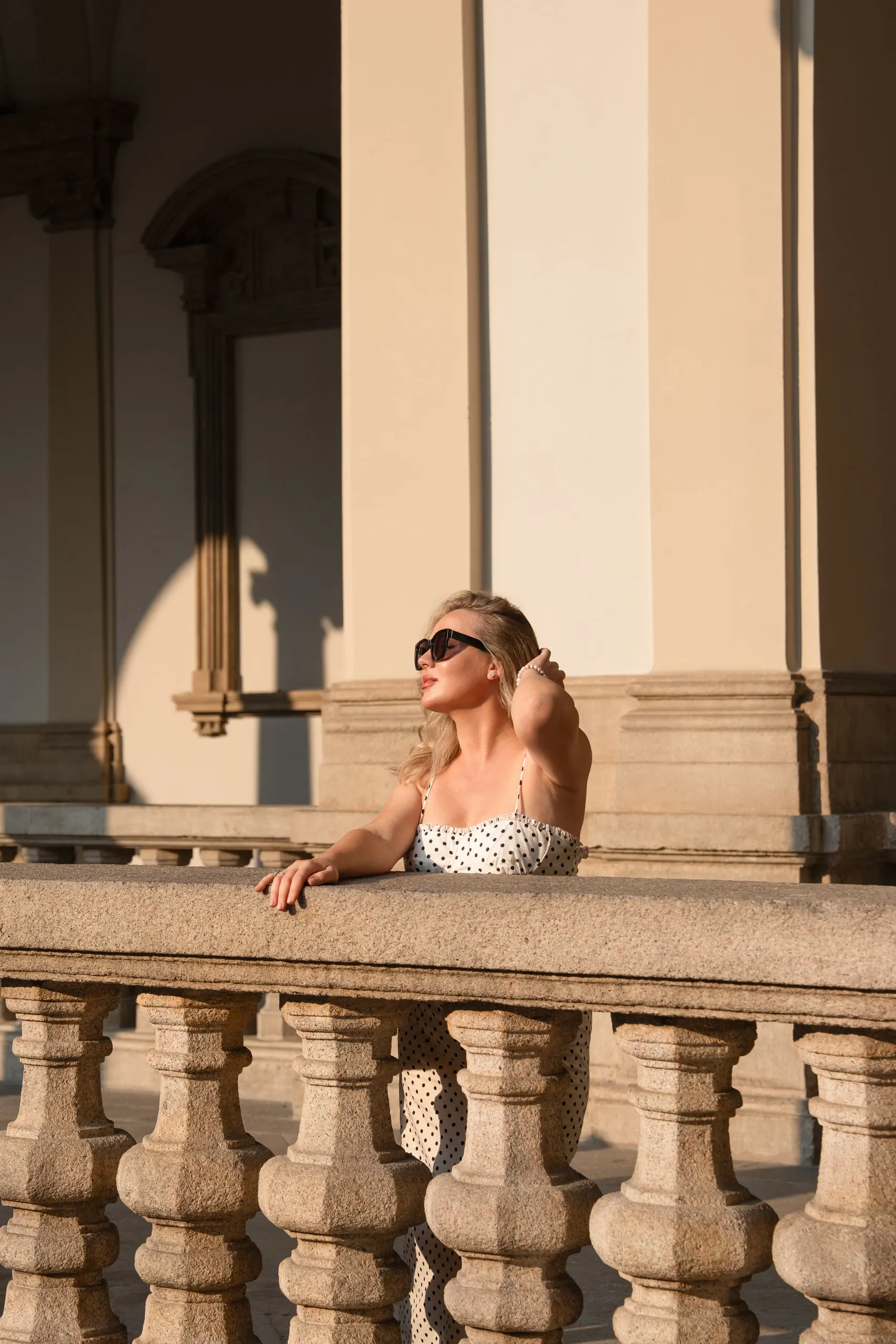 Yulia — a private shoot in Milan — by the balustrade in sunglasses